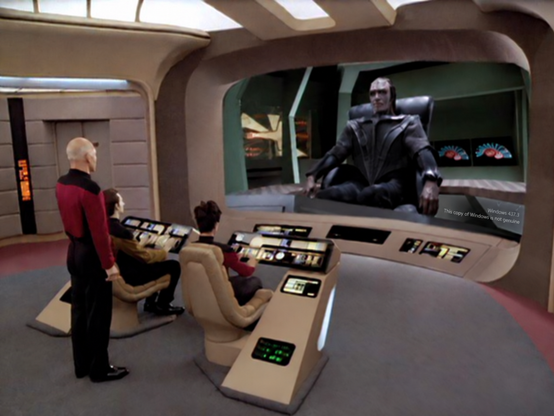 Image of the Star Trek next generation bridge with picard looking at the big screen talking to a romulan. There’s a small text on the screens lower right hand corner that says: Windows 437.3, This copy of Windows is not genuine