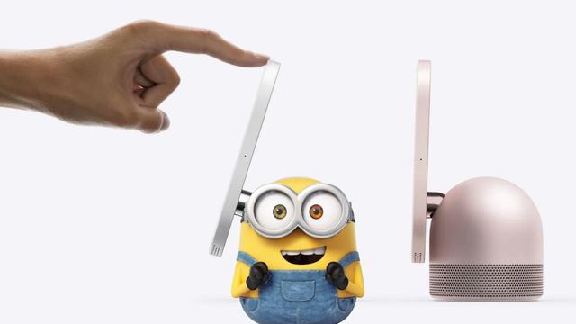 The promotion image of the HomeView, a sort of weird tiny iPad crossed with a Homepod thing Apple just announced that I don't care about. It's side on, showing the dome like shape, so all I could fucking think of because of the insane marketing success of those movies is the short Minion, who I learned while making this is called "Bob". So "Bob" replaces the left-most HomeView base. It's an image of Bob looking SUPER excited to be touched on his 7" panel. Anyway, I hope you enjoyed this alt text. I may have had a few mildly alcoholic beverages before writing it.